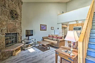 a living room with a couch and a fireplace at 2 Mi to Granby Ranch Condo with Hot Tub Access in Granby