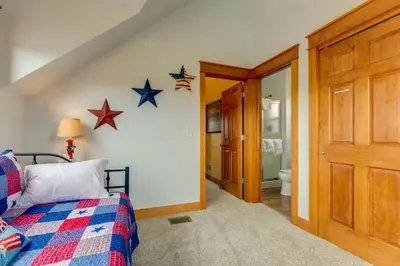 a bedroom with a bed with stars on the wall at Riverfront Cabin, 4 Mi to Granby Ranch in Granby