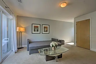 a living room with a couch and a table at LoHi Apartment with Patio 1 Mi to Downtown Denver! in Denver