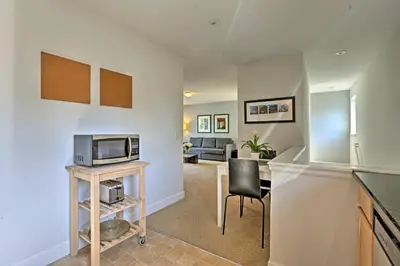 a kitchen and living room with a microwave at LoHi Apartment with Patio 1 Mi to Downtown Denver! in Denver