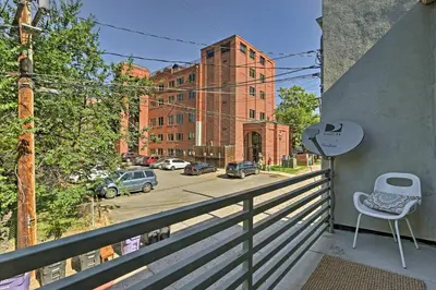 a balcony with a chair and a view of a street at LoHi Apartment with Patio 1 Mi to Downtown Denver! in Denver