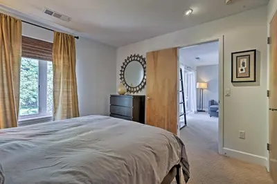 a bedroom with a large bed and a mirror at LoHi Apartment with Patio 1 Mi to Downtown Denver! in Denver