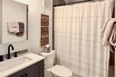 a bathroom with a toilet and a sink and a shower at Walk to Main St Frisco Condo with Community Pool! in Frisco
