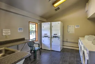 two white refrigerators in a kitchen with a chair at Walk to Main St Frisco Condo with Community Pool! in Frisco