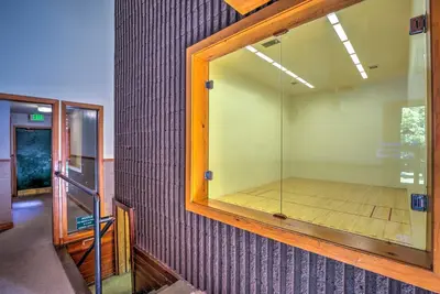 a room with a large glass window on a wall at Walk to Main St Frisco Condo with Community Pool! in Frisco
