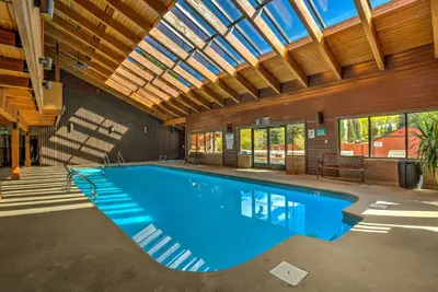 a swimming pool in a building with a ceiling at Walk to Main St Frisco Condo with Community Pool! in Frisco