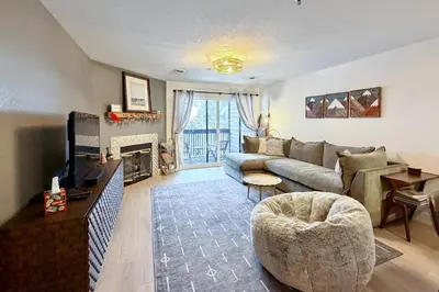 a living room with a couch and a fireplace at Walk to Main St Frisco Condo with Community Pool! in Frisco