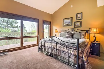 a bedroom with a bed and a large window at Estes Condo 3 Mi to Rocky Mountain National Park in Estes Park