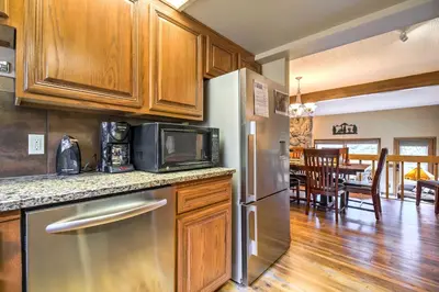 a kitchen with a stainless steel refrigerator and a dining room at Estes Condo 3 Mi to Rocky Mountain National Park in Estes Park