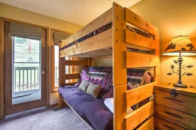 a bunk bed in a room with a purple couch at Estes Condo 3 Mi to Rocky Mountain National Park in Estes Park