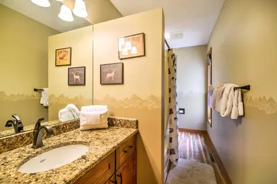a bathroom with a sink and a mirror at Estes Condo 3 Mi to Rocky Mountain National Park in Estes Park