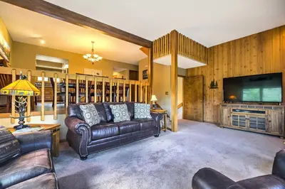 a living room with a couch and a flat screen tv at Estes Condo 3 Mi to Rocky Mountain National Park in Estes Park