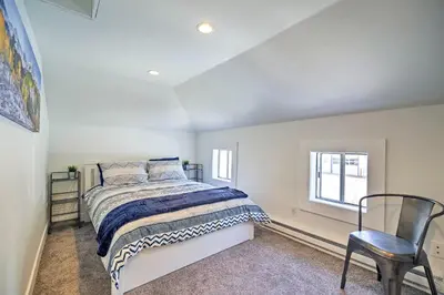 a bedroom with a bed and a chair at Dtwn Golden Apt Less Than 9 Mi to Red Rocks Amphitheater! in Golden