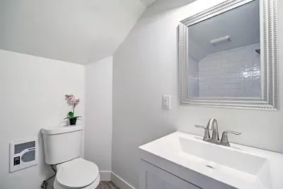 a white bathroom with a toilet and a sink at Dtwn Golden Apt Less Than 9 Mi to Red Rocks Amphitheater! in Golden