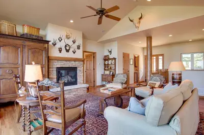 a living room with a couch and a fireplace at Lake and Mountain Views Stunning Estes Park Home! in Estes Park