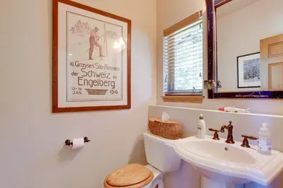 a bathroom with a white toilet and a sink at Lake and Mountain Views Stunning Estes Park Home! in Estes Park