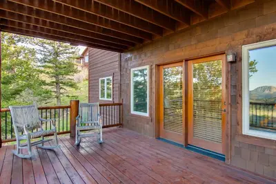 two chairs on the porch of a house at Lake and Mountain Views Stunning Estes Park Home! in Estes Park