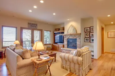 a living room with two couches and a fireplace at Lake and Mountain Views Stunning Estes Park Home! in Estes Park