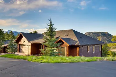 a wooden house with a tree in front of it at Lake and Mountain Views Stunning Estes Park Home! in Estes Park