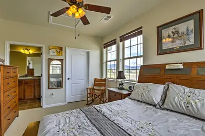 a bedroom with a bed and a ceiling fan at 18 Mi to Winter Park Granby Condo with Covered Deck in Granby
