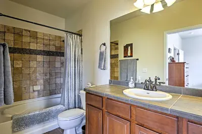 a bathroom with a sink and a toilet and a tub at 18 Mi to Winter Park Granby Condo with Covered Deck in Granby