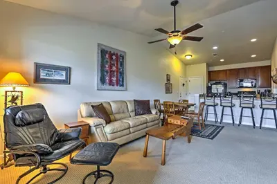 a living room with a couch and a table at 18 Mi to Winter Park Granby Condo with Covered Deck in Granby