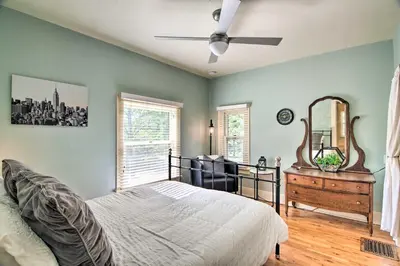 a bedroom with a bed and a ceiling fan at Historic Apartment - Walk to CSU Campus and Old Town in Fort Collins