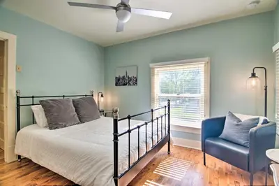 a bedroom with a bed and a blue chair at Historic Apartment - Walk to CSU Campus and Old Town in Fort Collins