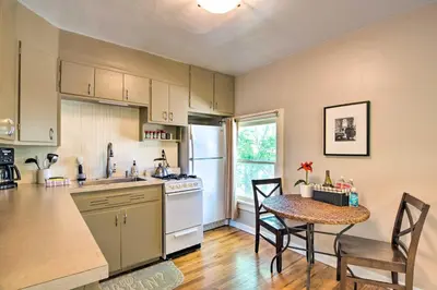 a kitchen with a table and a dining room at Historic Apartment - Walk to CSU Campus and Old Town in Fort Collins