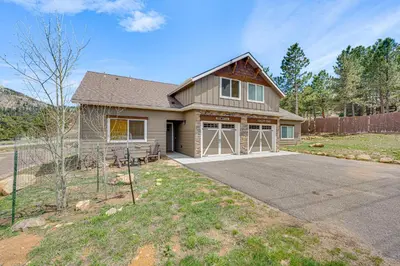 a house with a driveway in front of it at Newly Built Estes Park Townhome, 2 Miles to RMNP! in Estes Park