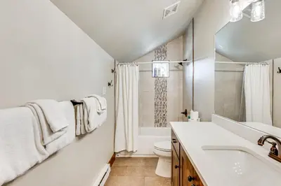 a white bathroom with a sink and a toilet at Newly Built Estes Park Townhome, 2 Miles to RMNP! in Estes Park