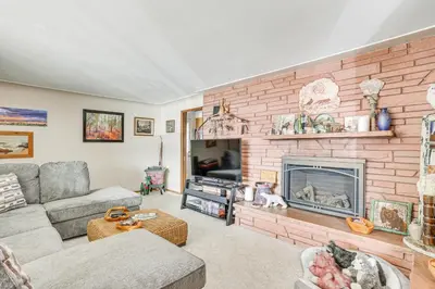 a living room with a couch and a fireplace at Private Lake Family Home with Large Yard in Denver! in Denver