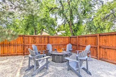 a patio with chairs and a table with a fire pit at Historic Redstone with Large Backyard, Walk To CSU! in Fort Collins