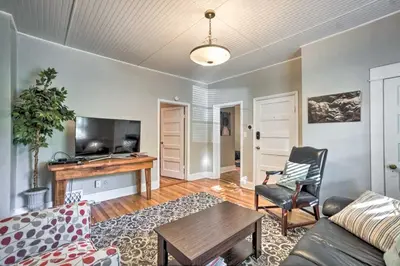 a living room with a couch and a table at Historic Redstone with Large Backyard, Walk To CSU! in Fort Collins