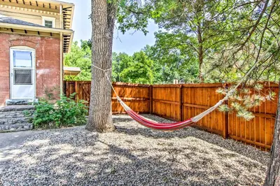 a hammock tied to a tree in a fence at Historic Redstone with Large Backyard, Walk To CSU! in Fort Collins