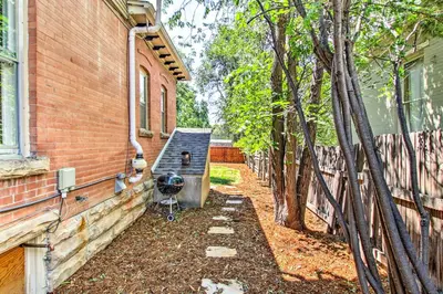 a backyard with a bench next to a house at Historic Redstone with Large Backyard, Walk To CSU! in Fort Collins