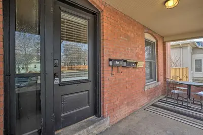 a black door on a brick building with a patio at Historic Redstone with Large Backyard, Walk To CSU! in Fort Collins