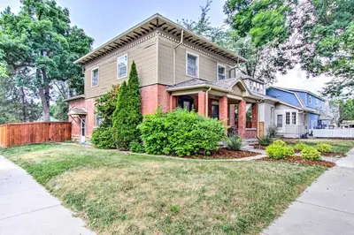 a house with a yard with a driveway at Historic Redstone with Large Backyard, Walk To CSU! in Fort Collins