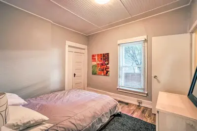 a bedroom with a bed and a window at Historic Redstone with Large Backyard, Walk To CSU! in Fort Collins