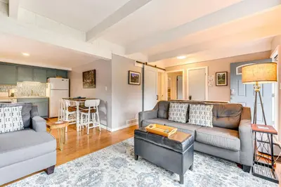 a living room with a couch and a table at Estes Park Condo with Deck and Views about 3 Miles to RMNP in Estes Park