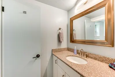 a bathroom with a sink and a mirror at Estes Park Condo with Deck and Views about 3 Miles to RMNP in Estes Park