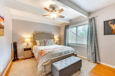 a bedroom with a bed and a ceiling fan at Estes Park Condo with Deck and Views about 3 Miles to RMNP in Estes Park