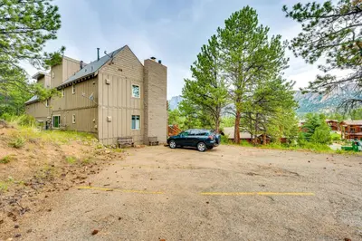 a car parked in a parking lot in front of a building at Estes Park Condo with Deck and Views about 3 Miles to RMNP in Estes Park