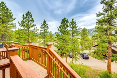 a wooden balcony with a view of a parking lot at Estes Park Condo with Deck and Views about 3 Miles to RMNP in Estes Park