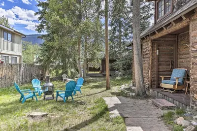 a group of chairs in the yard of a cabin at Walk to Grand Lake Historic Dtwn Cabin! in Grand Lake