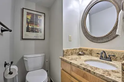 a bathroom with a sink and a mirror at Creekside Frisco Condo with Views and Pool Access! in Frisco
