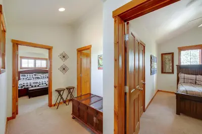 a room with a door open to a bedroom at Grand Elk Golf Club On-Site Mtn-View Home with Deck in Granby