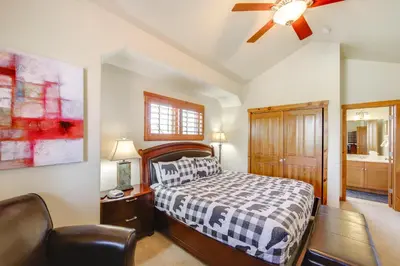 a bedroom with a bed and a ceiling fan at Grand Elk Golf Club On-Site Mtn-View Home with Deck in Granby