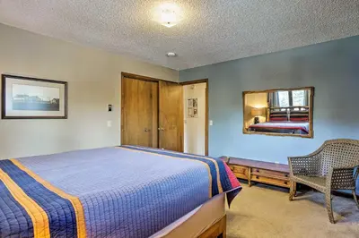 a bedroom with a bed and a mirror on the wall at Peaceful Pines Estes Park Home Longs Peak View in Estes Park