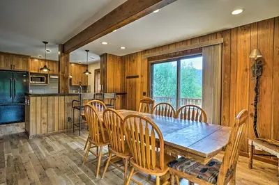a kitchen and dining room with a wooden table and chairs at Peaceful Pines Estes Park Home Longs Peak View in Estes Park